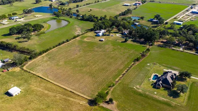 a view of a swimming pool with a yard and outdoor seating