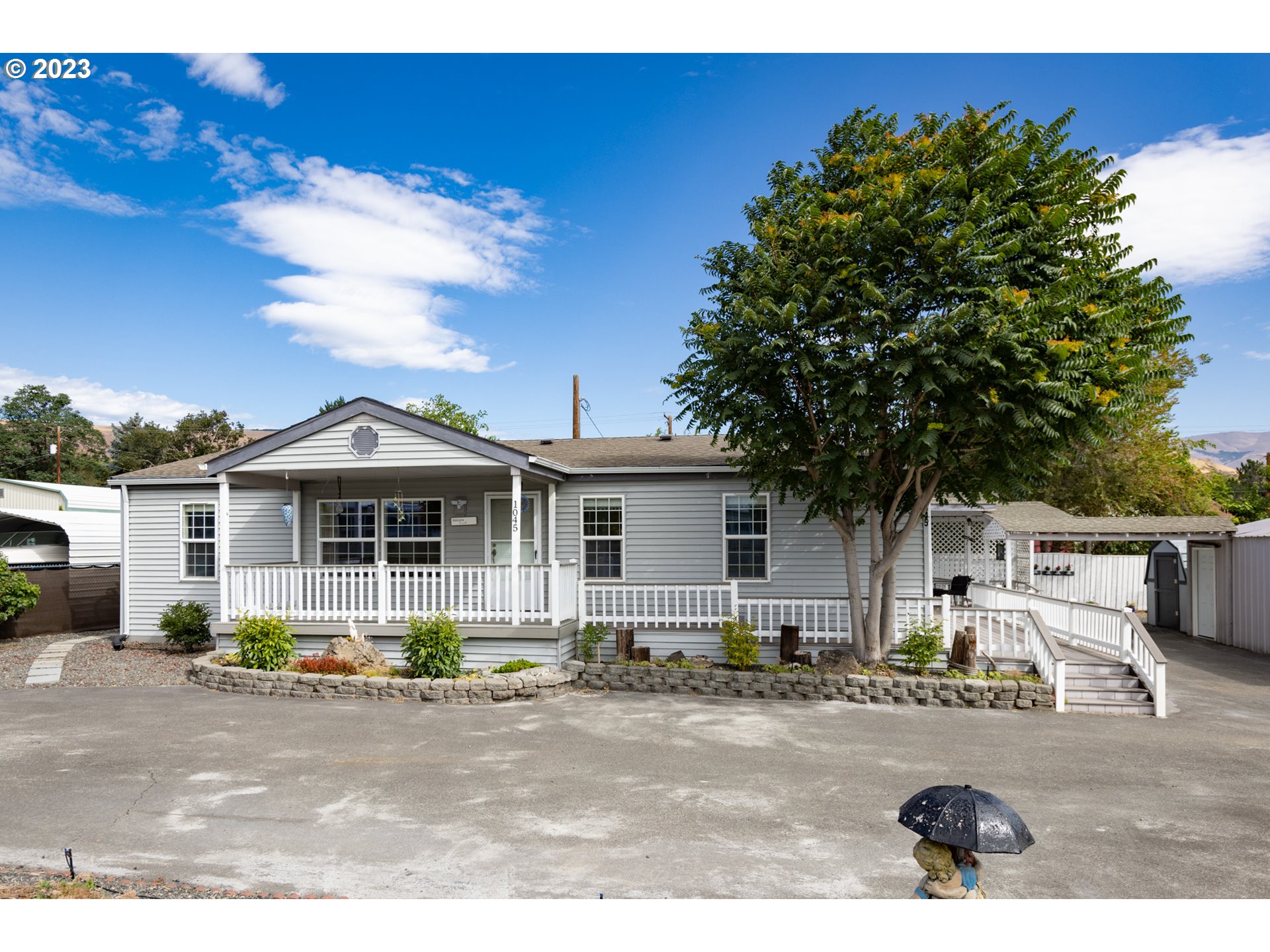 1045 Chenoweth Road The Dalles, OR 97058 - Photo 1 of 35 a view of a house with backyard and sitting area