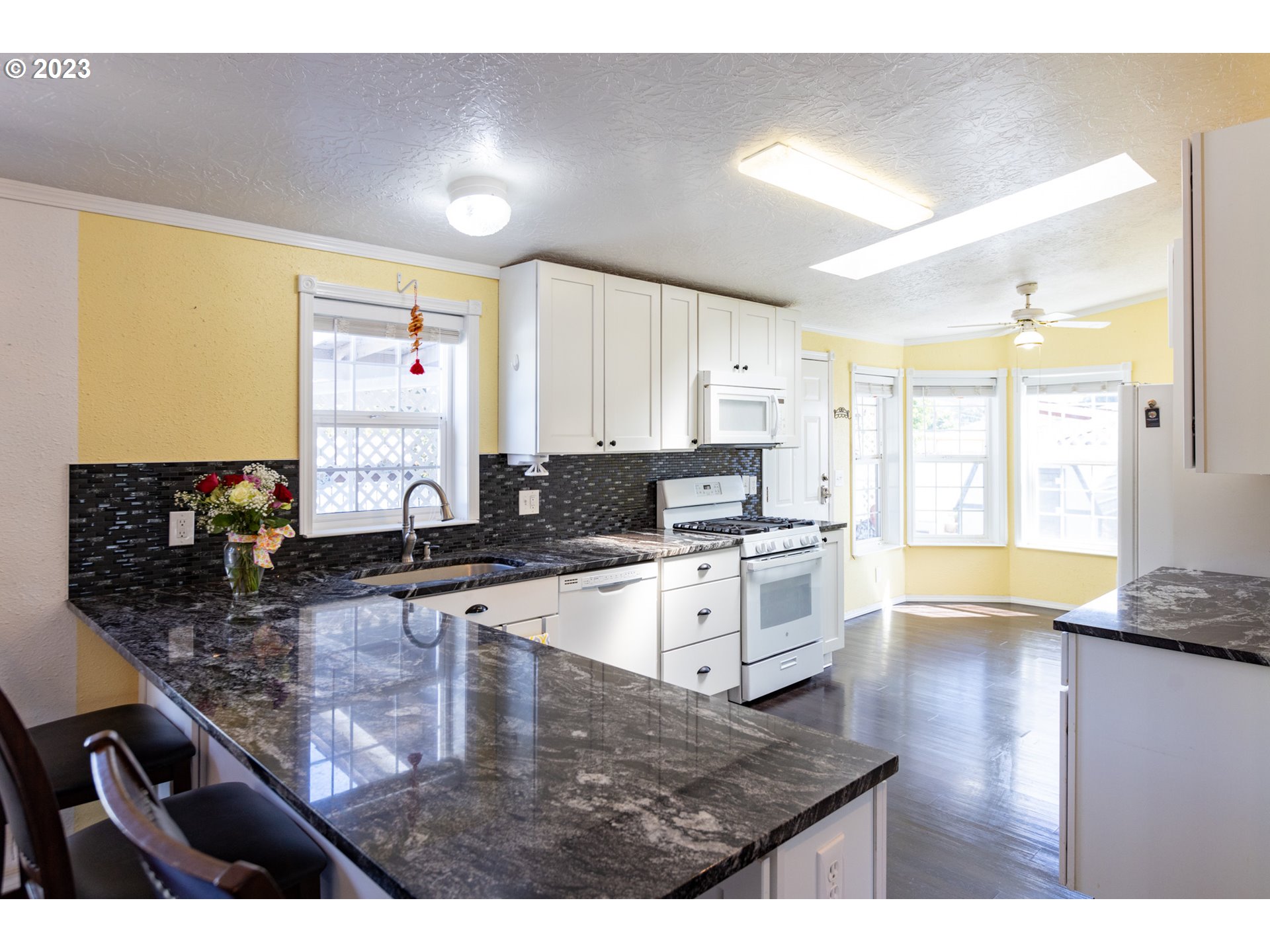 1045 Chenoweth Road The Dalles, OR 97058 - Photo 12 of 35 a kitchen with stainless steel appliances granite countertop a sink counter space and cabinets