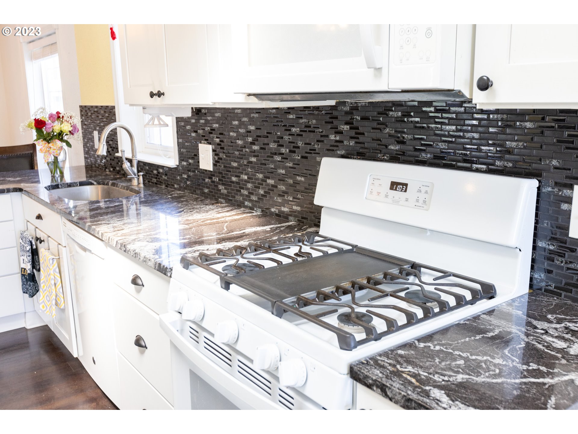 1045 Chenoweth Road The Dalles, OR 97058 - Photo 14 of 35 a kitchen with a stove a sink and a microwave