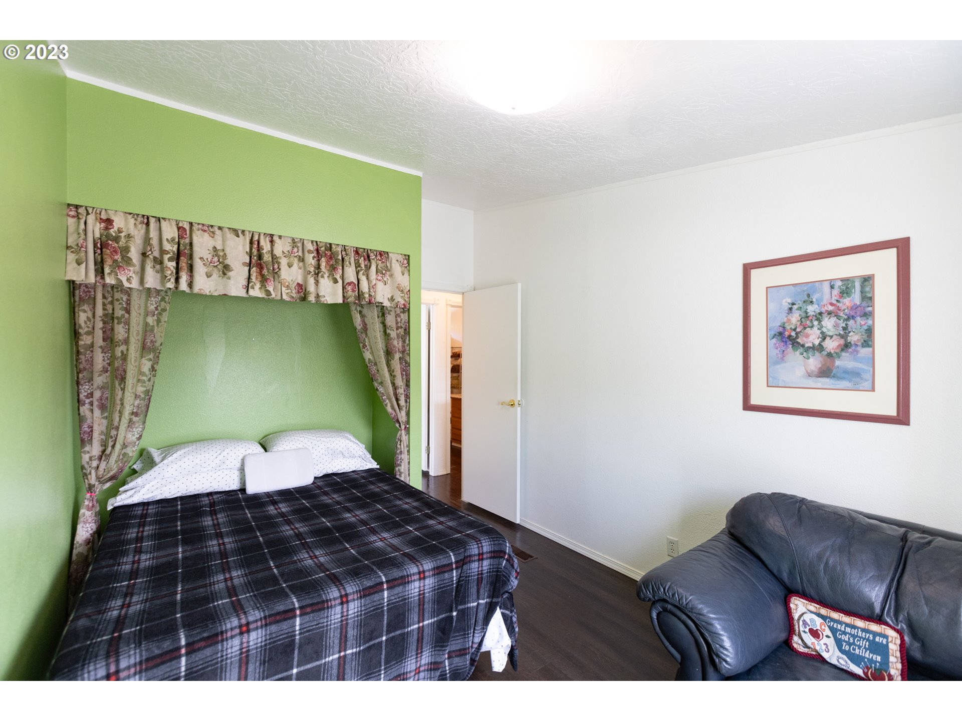 1045 Chenoweth Road The Dalles, OR 97058 - Photo 22 of 35 a bedroom with a bed and a chair