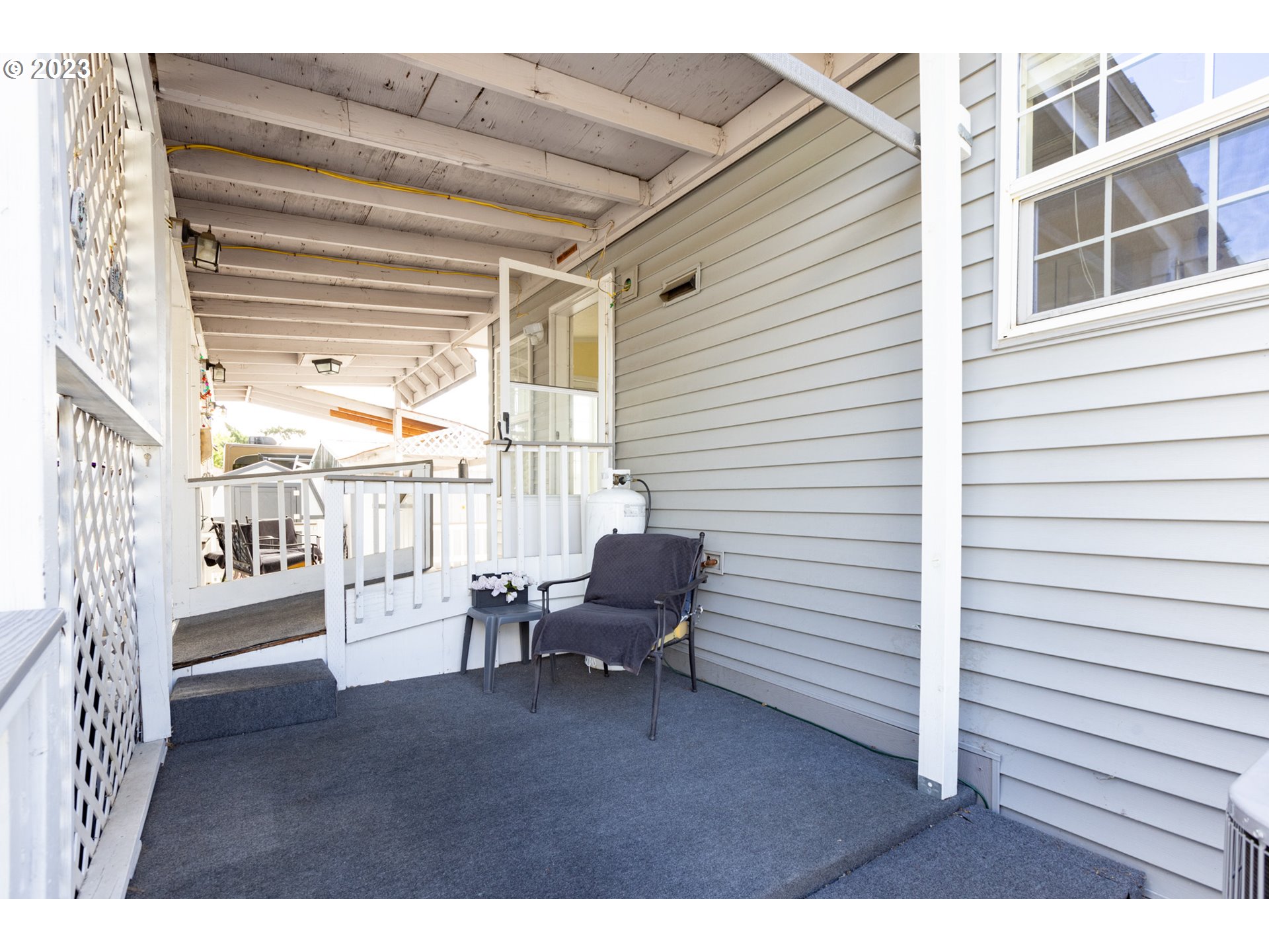 1045 Chenoweth Road The Dalles, OR 97058 - Photo 28 of 35 a view of a patio with table and chairs and wooden floor