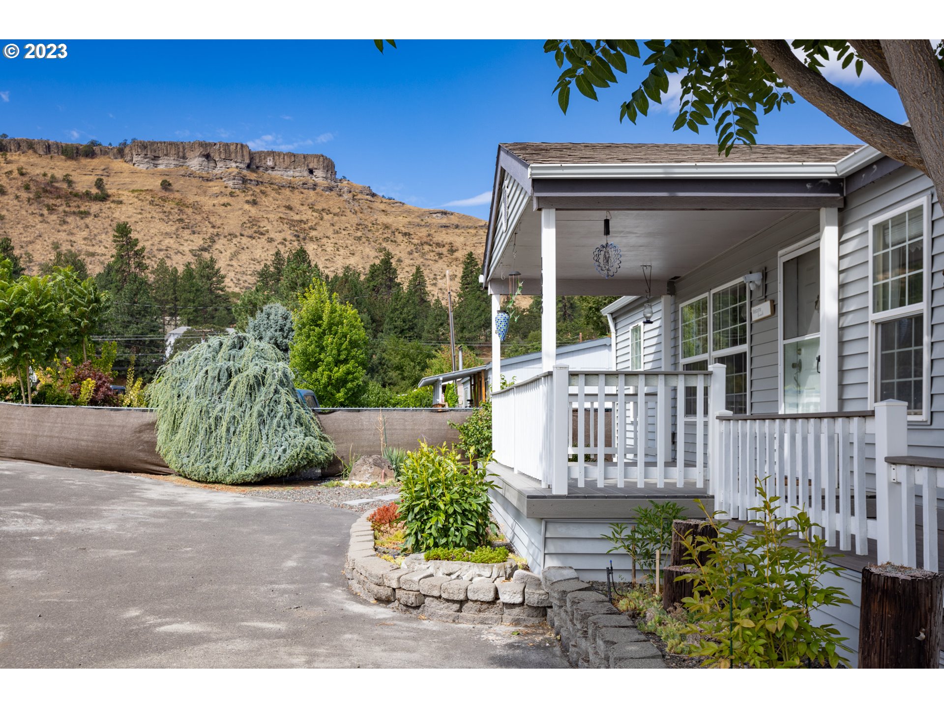 1045 Chenoweth Road The Dalles, OR 97058 - Photo 9 of 35 a view of a house with a flower garden