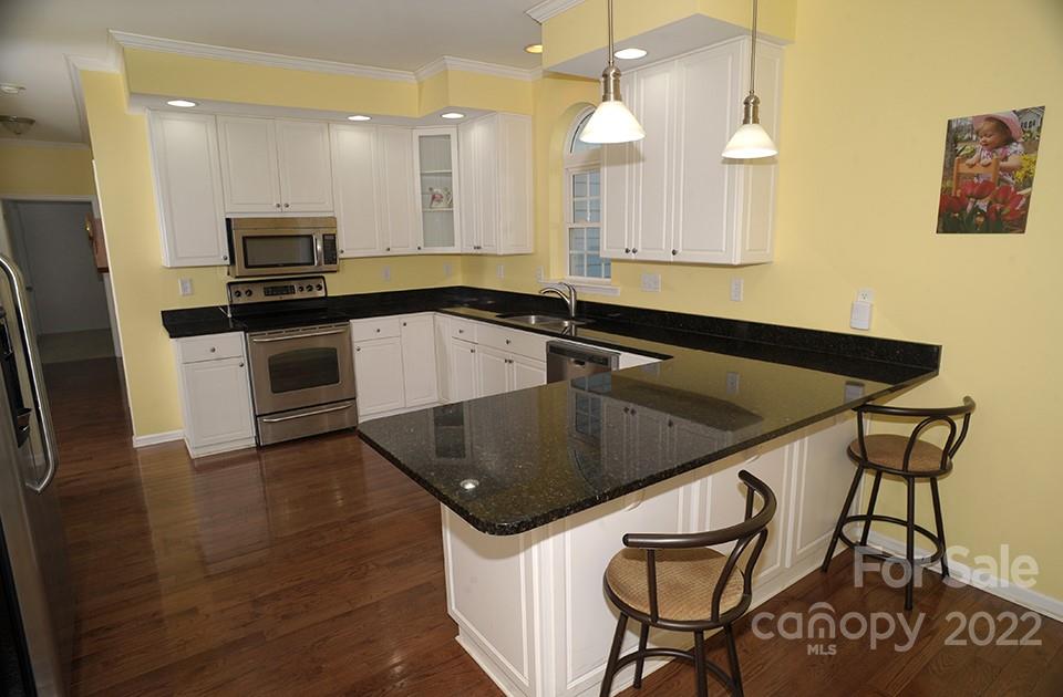 490 Cress Road Mount Ulla, NC 28125 - Photo 12 of 23 a kitchen with granite countertop a stove and a sink
