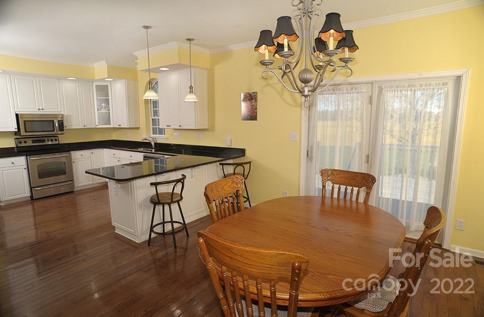 490 Cress Road Mount Ulla, NC 28125 - Photo 14 of 23 a dining room with furniture and wooden floor