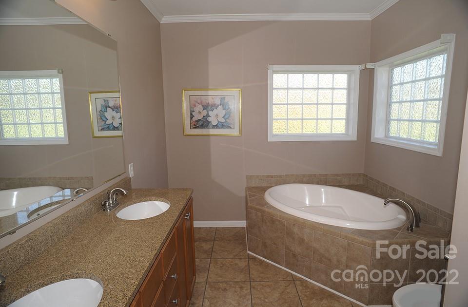 490 Cress Road Mount Ulla, NC 28125 - Photo 17 of 23 a bath room with a sink mirror and a toilet