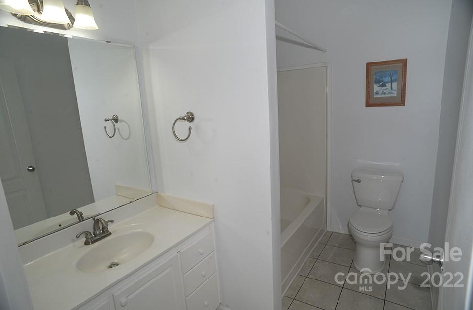490 Cress Road Mount Ulla, NC 28125 - Photo 20 of 23 a bathroom with a granite countertop toilet and a sink