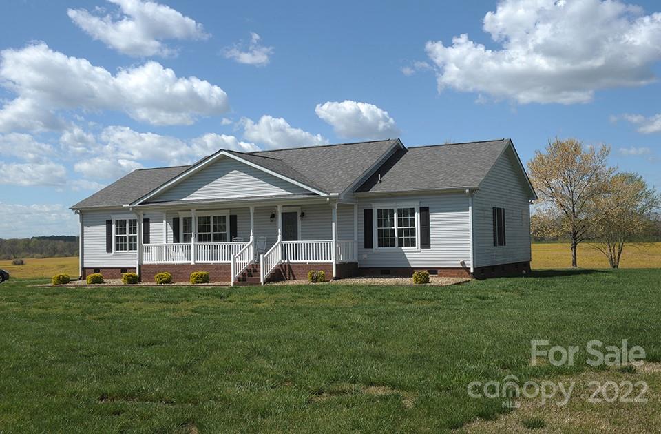 490 Cress Road Mount Ulla, NC 28125 - Photo 3 of 23 a front view of a house with a garden and pathway