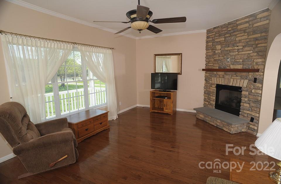 490 Cress Road Mount Ulla, NC 28125 - Photo 6 of 23 a living room with furniture large window and a fireplace
