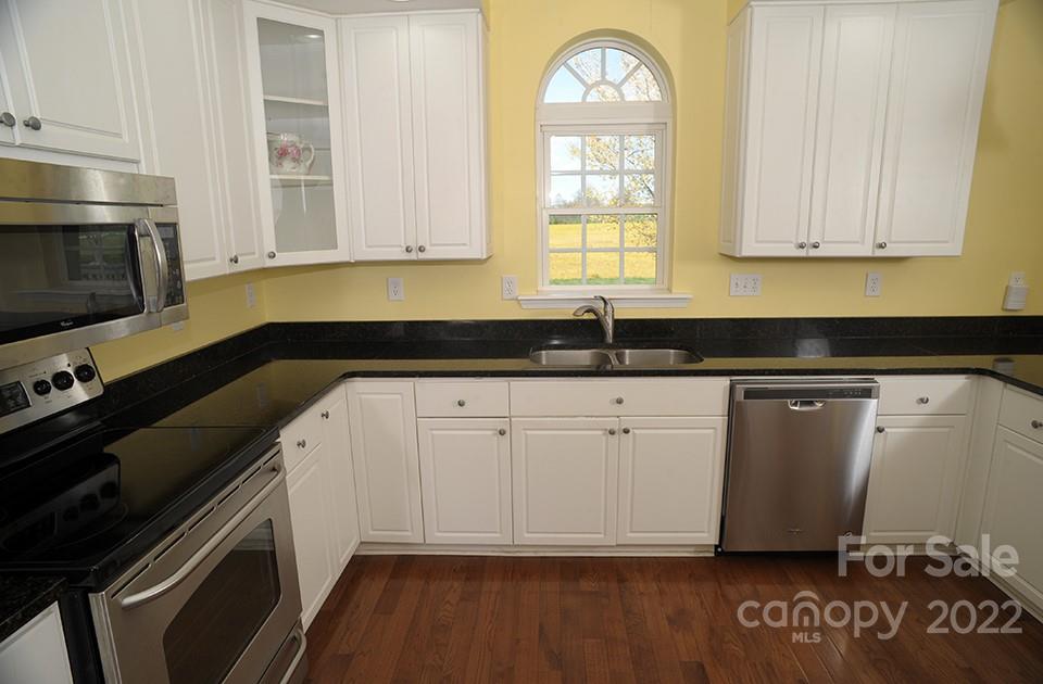 490 Cress Road Mount Ulla, NC 28125 - Photo 8 of 23 a kitchen with granite countertop a stove a sink and a microwave