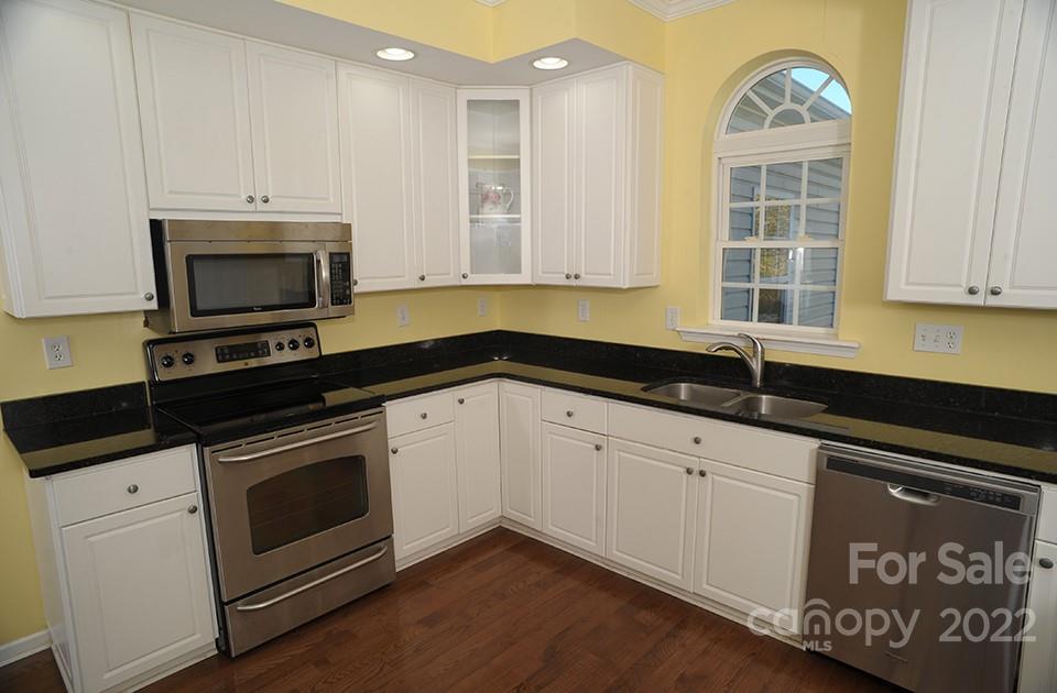 490 Cress Road Mount Ulla, NC 28125 - Photo 9 of 23 a kitchen with granite countertop white cabinets stainless steel appliances and a sink