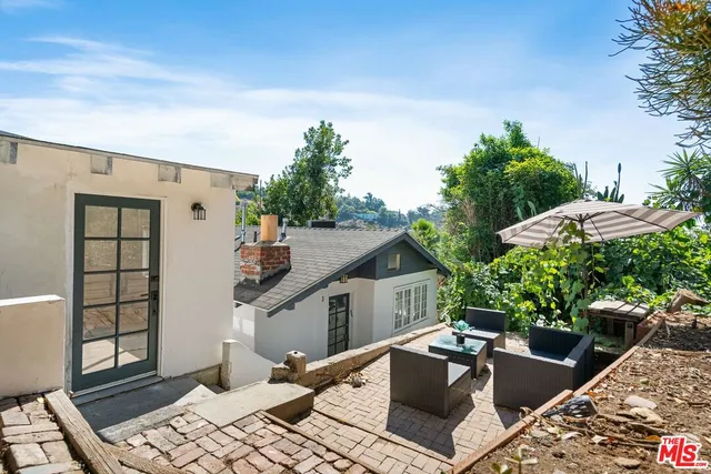 a view of house with swimming pool outdoor seating