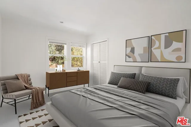 a bedroom with a large bed and couch