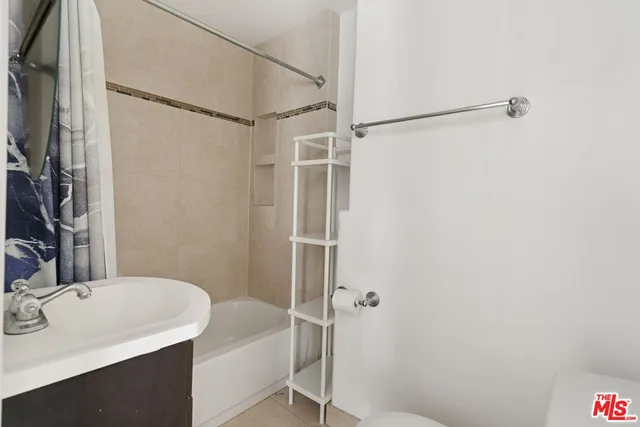 a bathroom with a sink and shower