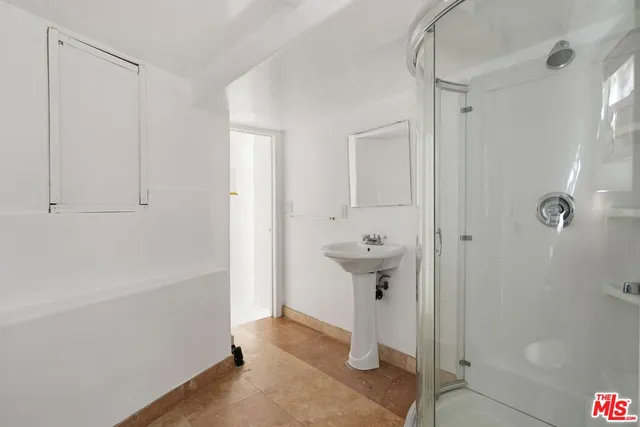 a bathroom with a sink and shower