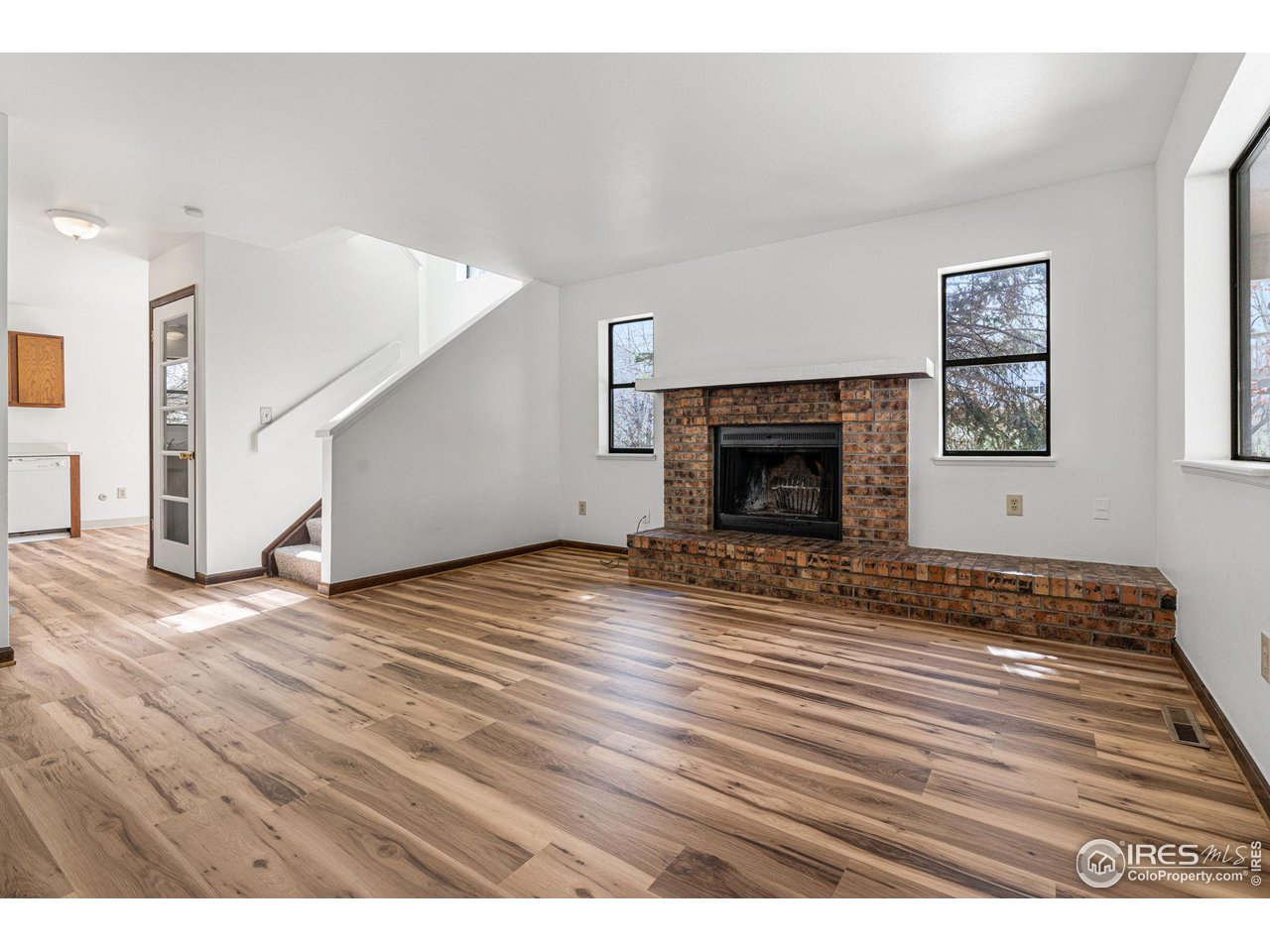 4640 Portside Way Boulder, CO 80301 - Photo 2 of 35 a view of empty room with wooden floor and fireplace