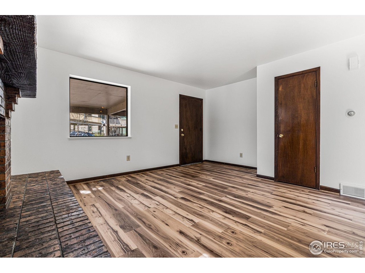 4640 Portside Way Boulder, CO 80301 - Photo 9 of 35 a view of an empty room with wooden floor and a window