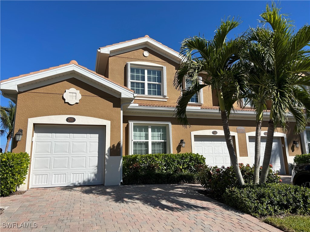 18230 Creekside Preserve Loop, Unit 101 Fort Myers, FL 33908 - Photo 1 of 16 a front view of a house with a yard