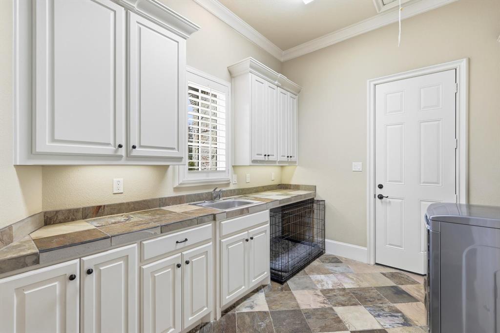 476 Hidden Valley Lane Coppell, TX 75019 - Photo 26 of 40 a kitchen with stainless steel appliances granite countertop a sink and a granite counter tops
