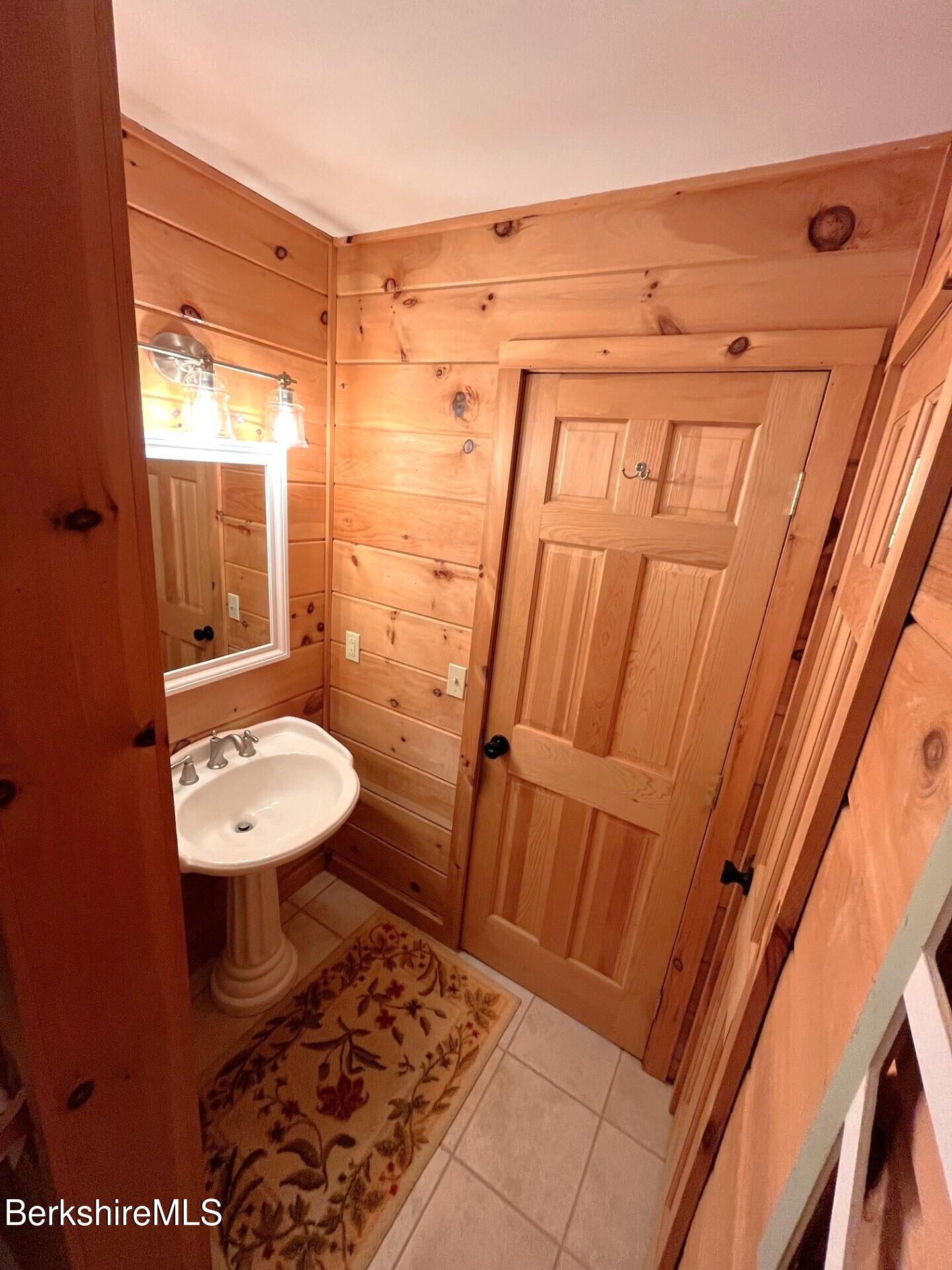 1020 Cascade Street Pittsfield, MA 01201 - Photo 14 of 75 a bathroom with a sink a toilet a mirror and vanity