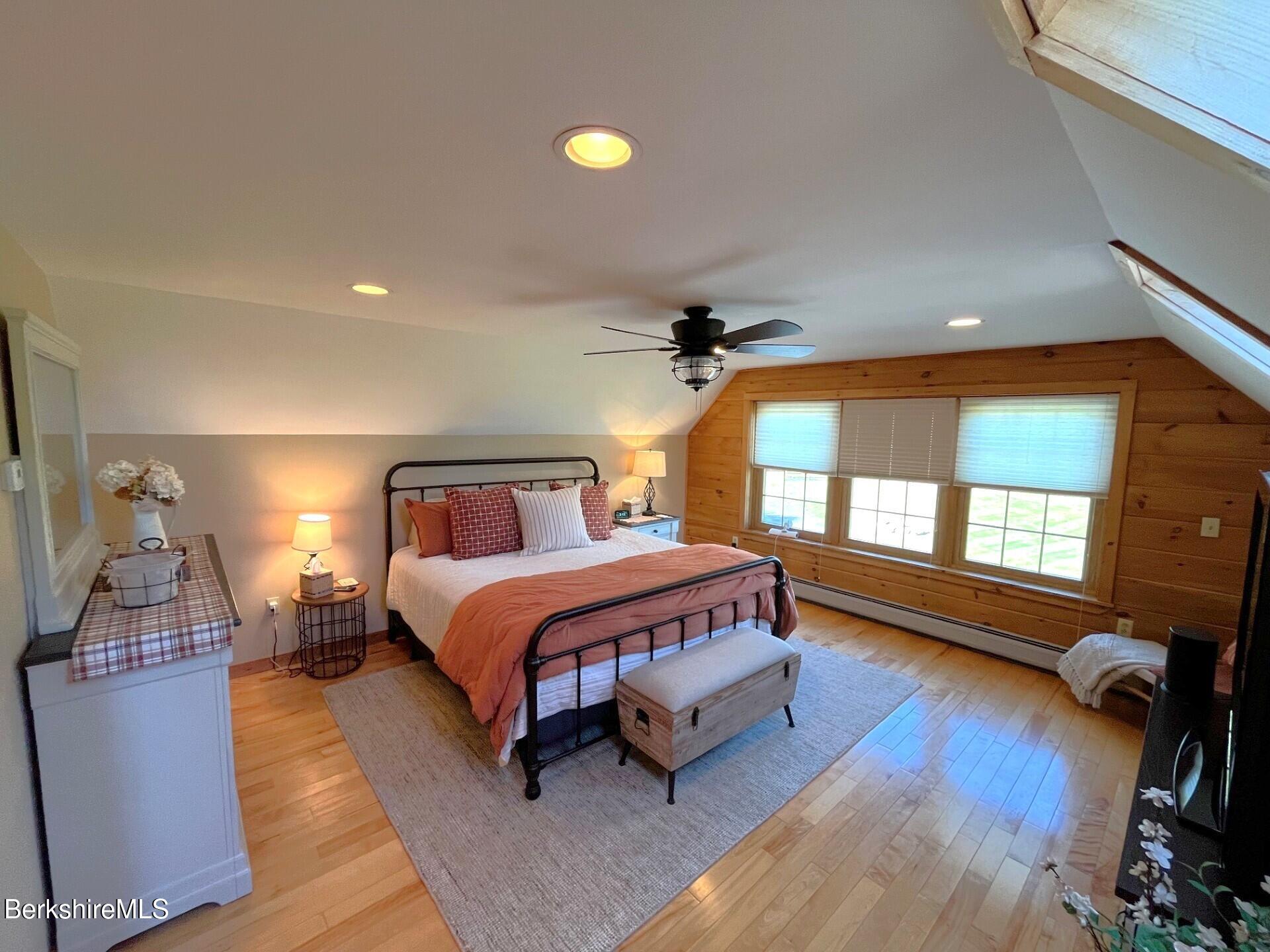 1020 Cascade Street Pittsfield, MA 01201 - Photo 34 of 75 a spacious bedroom with a bed a window and wooden floor