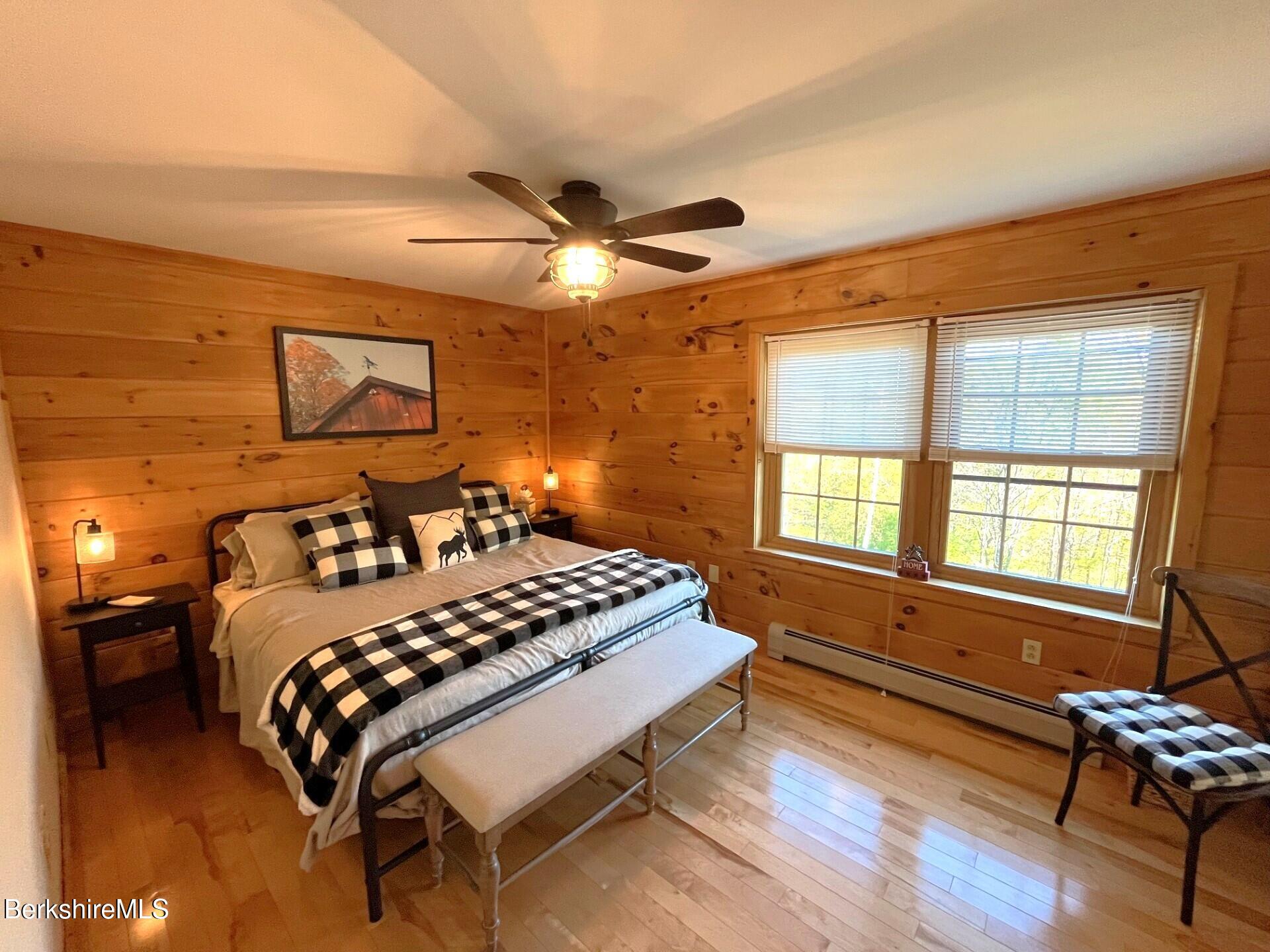 1020 Cascade Street Pittsfield, MA 01201 - Photo 40 of 75 a bedroom with a bed and wooden floor