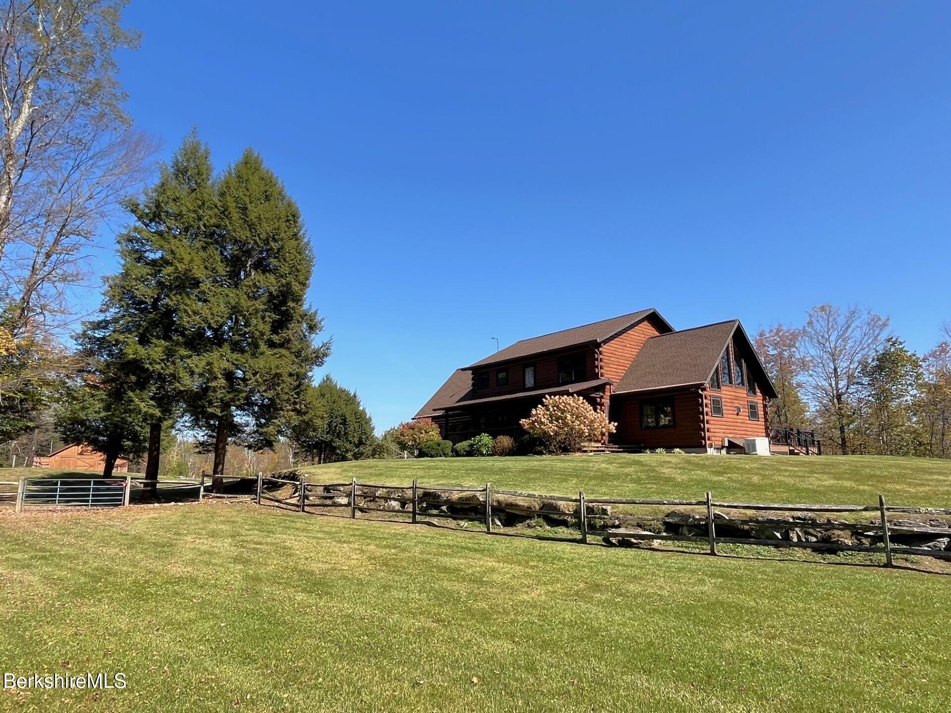 1020 Cascade Street Pittsfield, MA 01201 - Photo 7 of 75 a front view of a house with a yard and garage