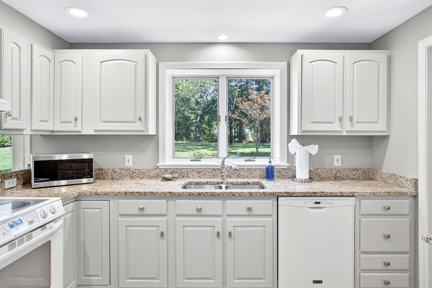 12 Paddocks Path East Dennis, MA 02638 - Photo 26 of 64 a kitchen with granite countertop white cabinets and white appliances