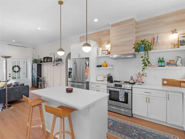 a kitchen with a sink a stove and chairs
