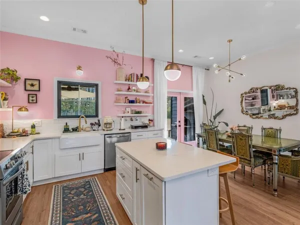 a kitchen with a sink a stove and chairs