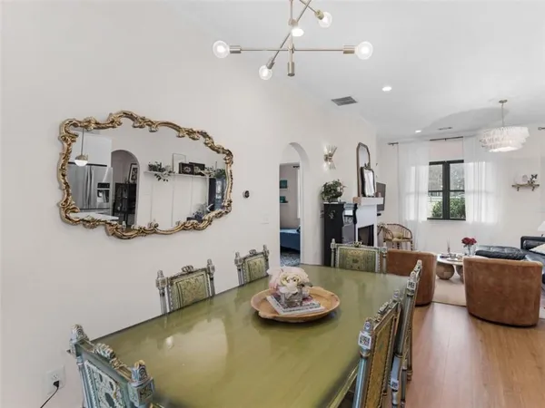 a bedroom with a bed and dresser with mirror