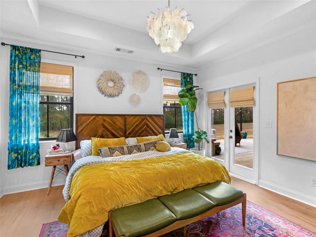 701 Marks Road Mansfield, GA 30055 - Photo 19 of 50 a bedroom with a large bed and a chandelier