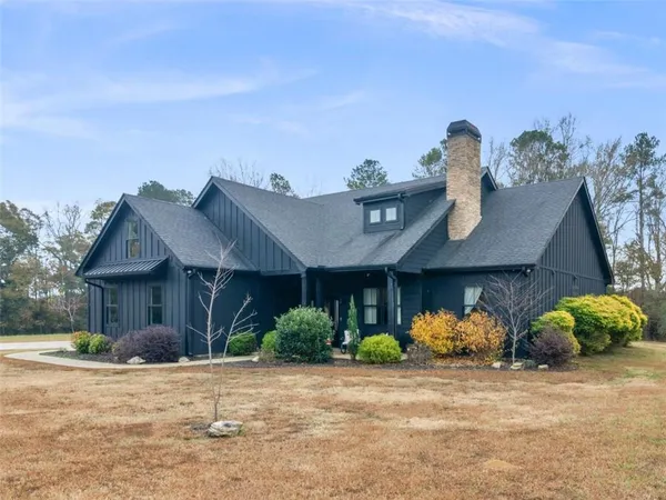 a front view of a house with a yard and a garage