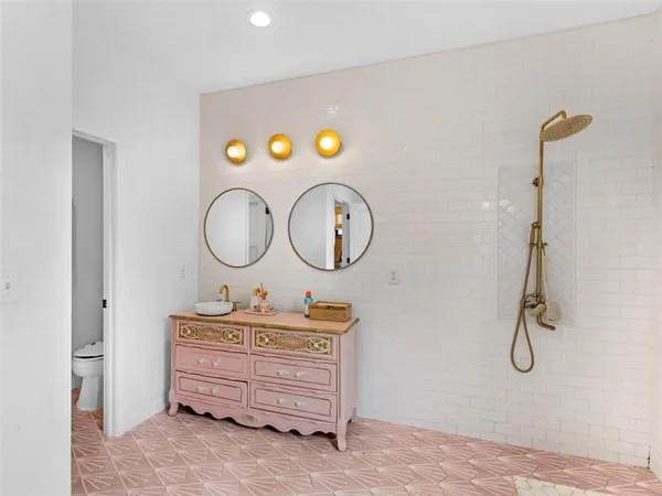 a bathroom with a tub sink and mirror