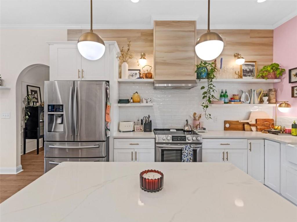 701 Marks Road Mansfield, GA 30055 - Photo 7 of 50 a kitchen with granite countertop a stove a refrigerator and a sink
