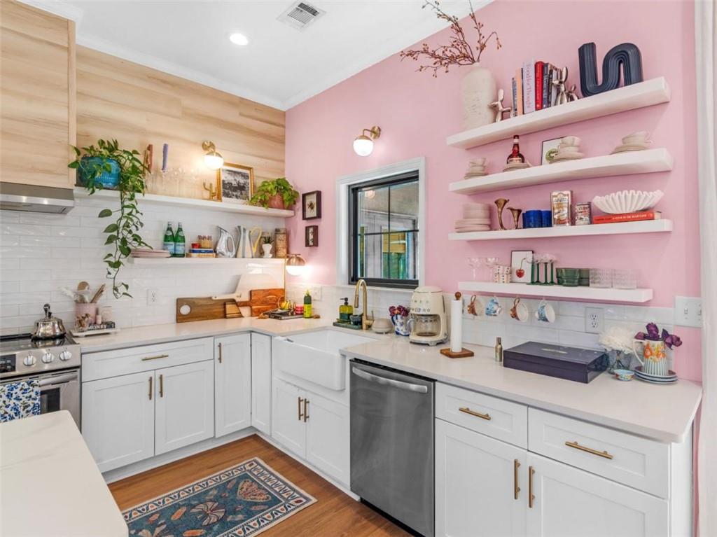 701 Marks Road Mansfield, GA 30055 - Photo 10 of 50 a kitchen with a sink dishwasher and white cabinets next to a window