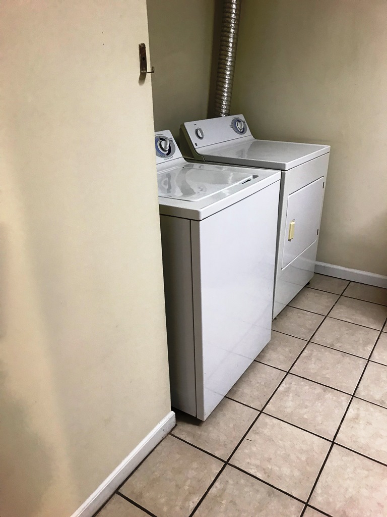406 Old Central Road, Unit 1 Clemson, SC 29631 - Photo 8 of 8 This dedicated laundry space offers convenience with essential appliances and durable flooring.