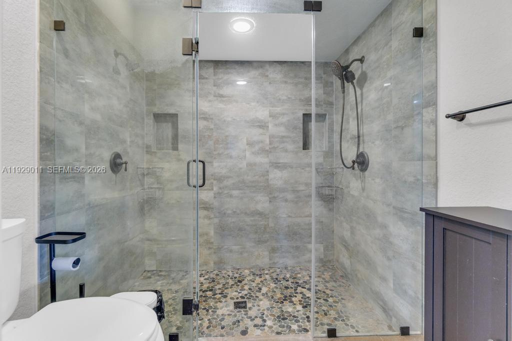 16900 Southwest 276th Street Homestead, FL 33031 - Photo 12 of 22 a bathroom with a shower and toilet
