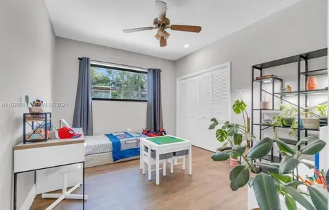 a bathroom with a granite countertop sink a mirror and shower