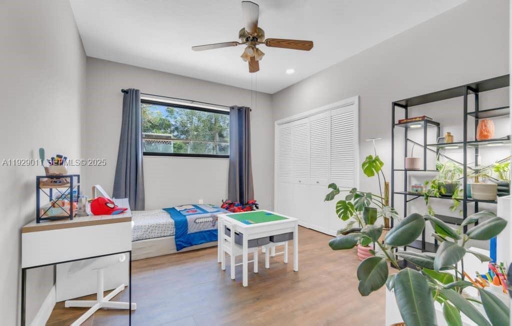 16900 Southwest 276th Street Homestead, FL 33031 - Photo 15 of 22 a living room with furniture dining table a chandelier and a potted plant
