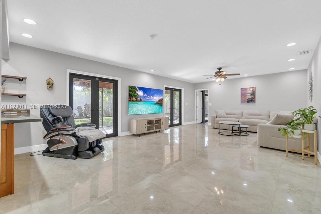 16900 Southwest 276th Street Homestead, FL 33031 - Photo 2 of 22 a view of a livingroom with workspace and a couch