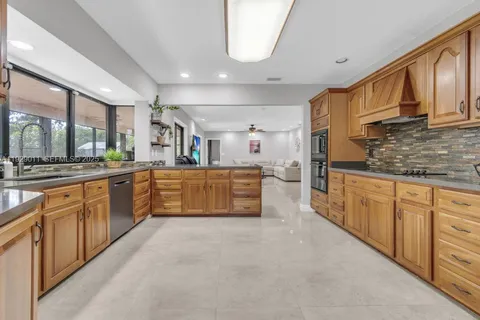 a large kitchen with stainless steel appliances lots of counter top space