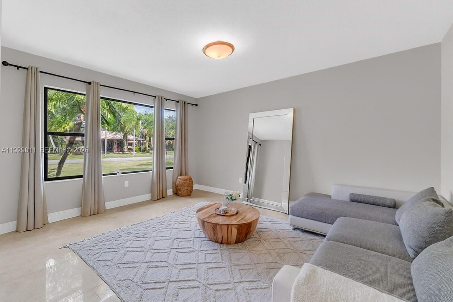 16900 Southwest 276th Street Homestead, FL 33031 - Photo 3 of 22 a living room with furniture and a floor to ceiling window