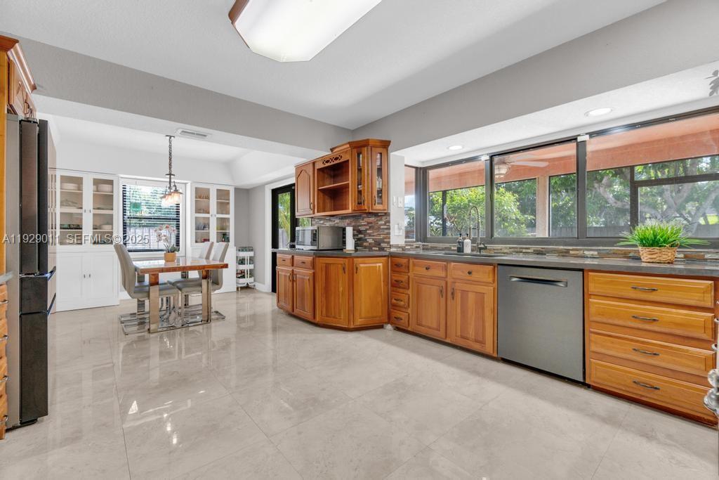 16900 Southwest 276th Street Homestead, FL 33031 - Photo 7 of 22 a kitchen with a large window and dining table