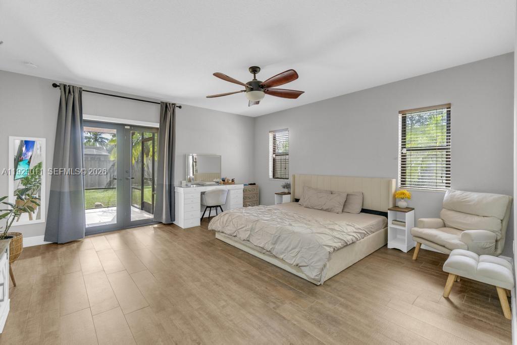 16900 Southwest 276th Street Homestead, FL 33031 - Photo 10 of 22 a spacious bedroom with a bed and a chandelier