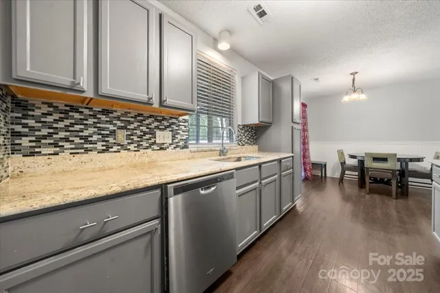 a kitchen with sink and cabinets