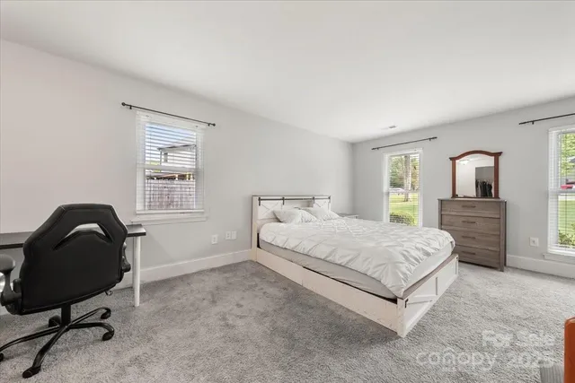 a bedroom with a bed and a chair