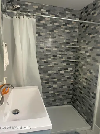 a bathroom with a bathtub and shower