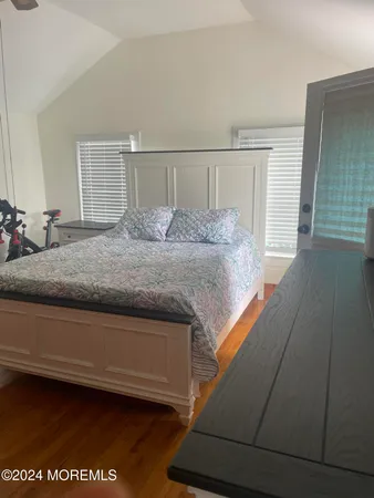 a bedroom with a bed and a night stand