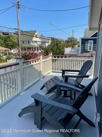 a view of a balcony with chairs
